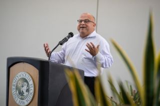 Jake Diaz speaking at a podium